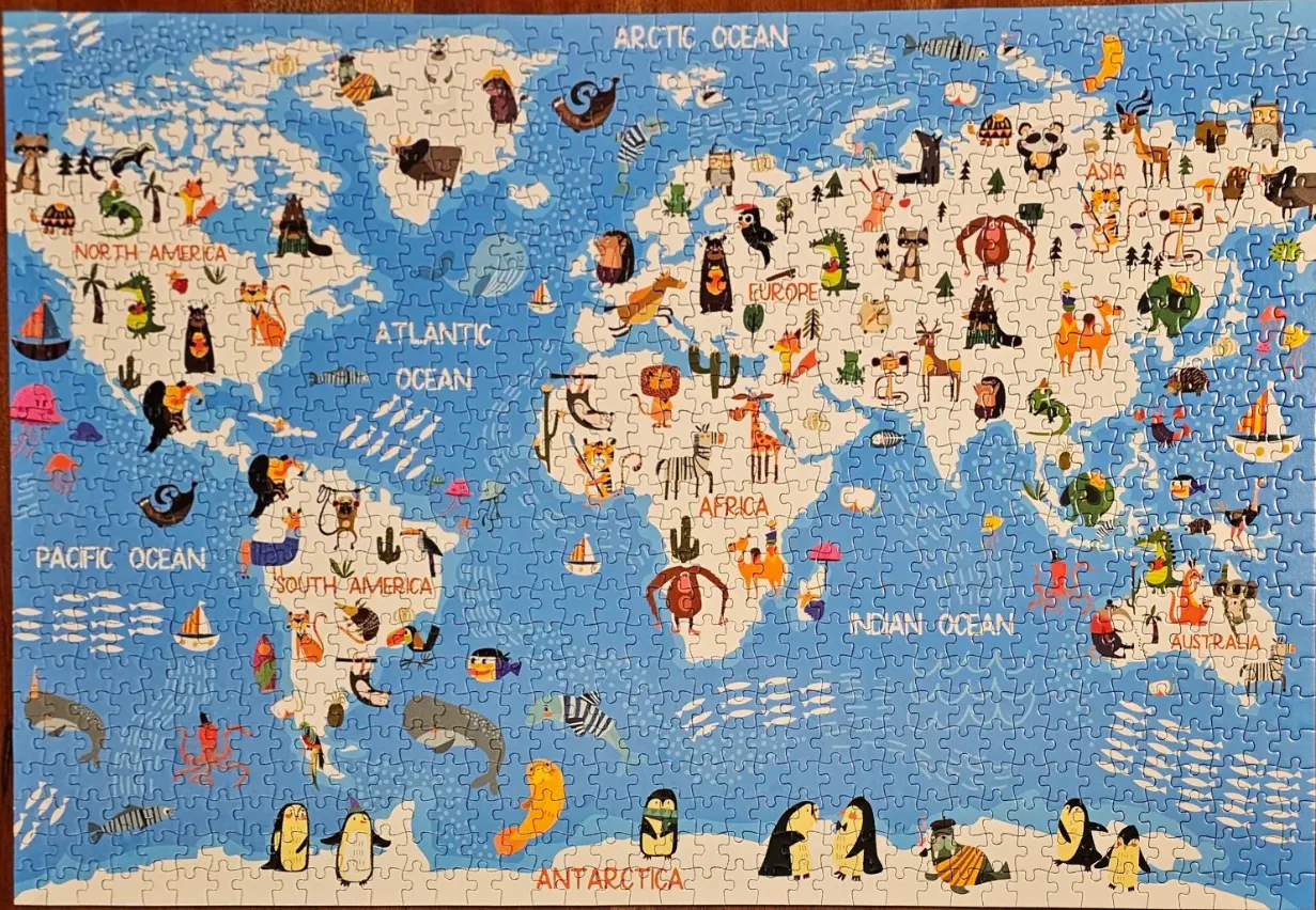Illustrated world map featuring cartoon animals on each continent