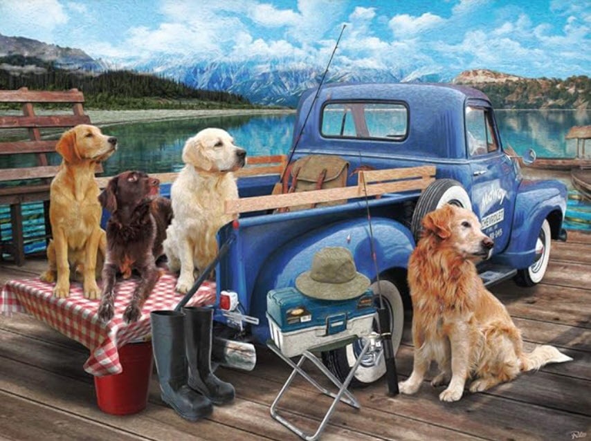 Four dogs gathered around a blue vintage pickup truck parked on a wooden dock by a mountain lake.