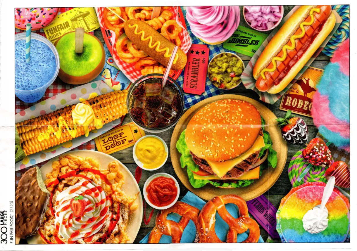 A top-down view of a colorful spread of classic state fair carnival foods.