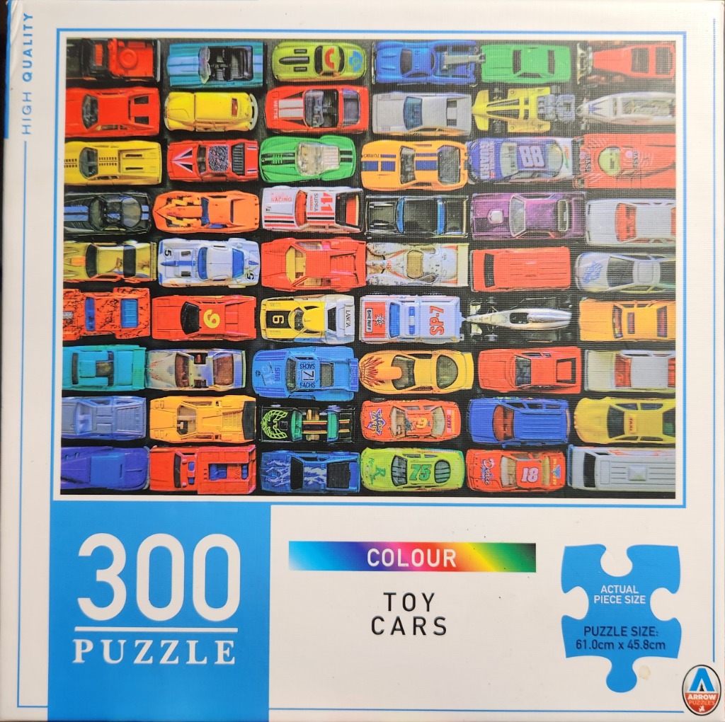A collection of many miniature toy cars arranged in a grid pattern.