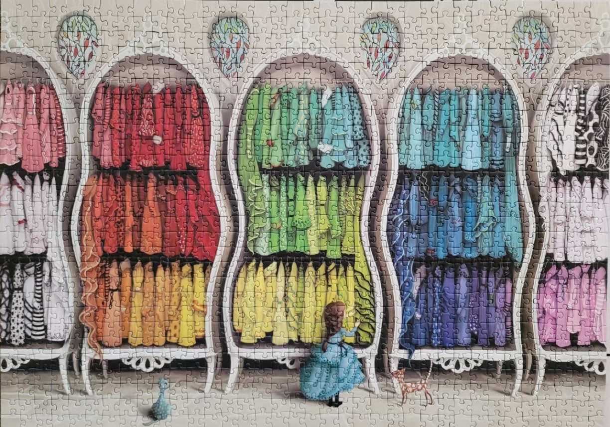 An illustration of a girl in a blue dress exploring a large closet filled with rainbow-colored clothing.