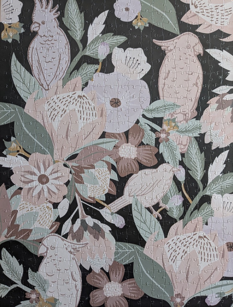 A botanical illustration featuring soft pink cockatoos and stylized flowers against a solid black background.