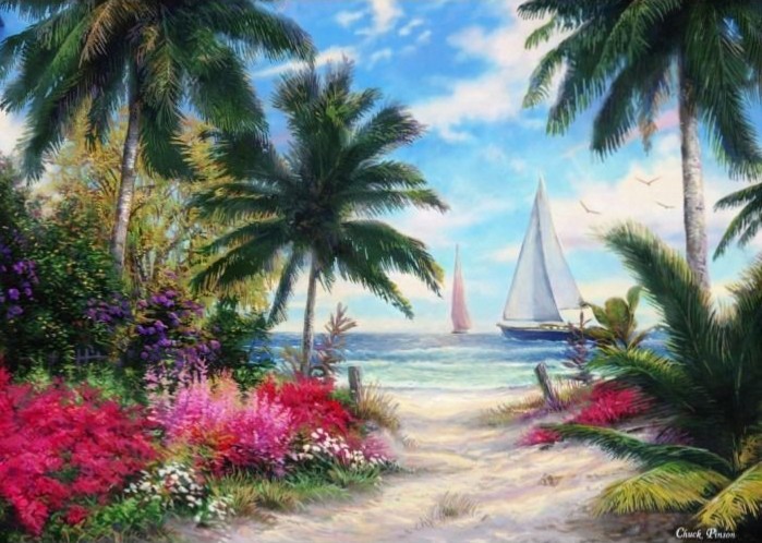 A tropical beach path leads to the ocean with sailboats on the horizon under a bright blue sky.