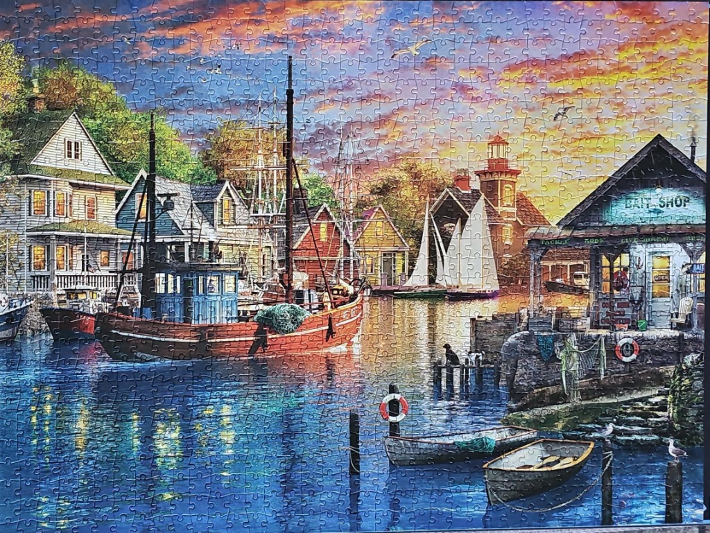 A peaceful coastal harbor scene at sunset featuring a red fishing boat and a bait shop.