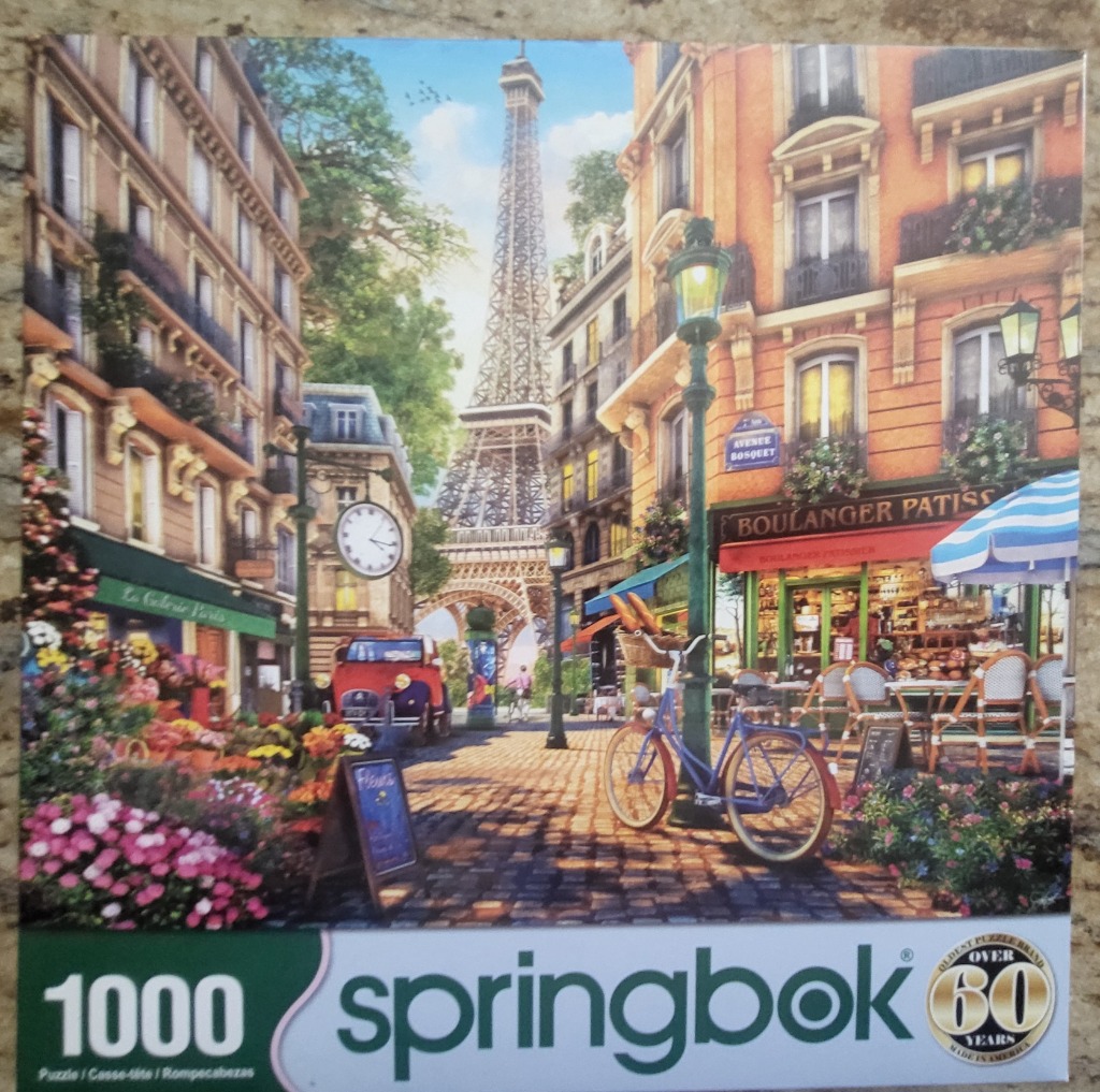 A sunny Parisian street scene with the Eiffel Tower in the distance, featuring a bakery, flowers, and a bicycle.