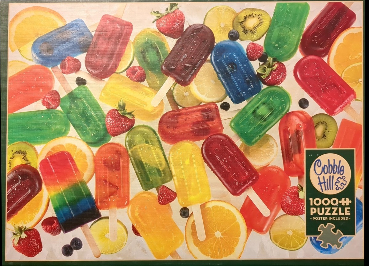 A vibrant assortment of colorful fruit popsicles and fresh fruit slices scattered on a white background.