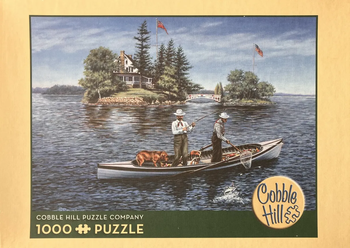 Two men in a boat fishing near a lake island with a house and flags.