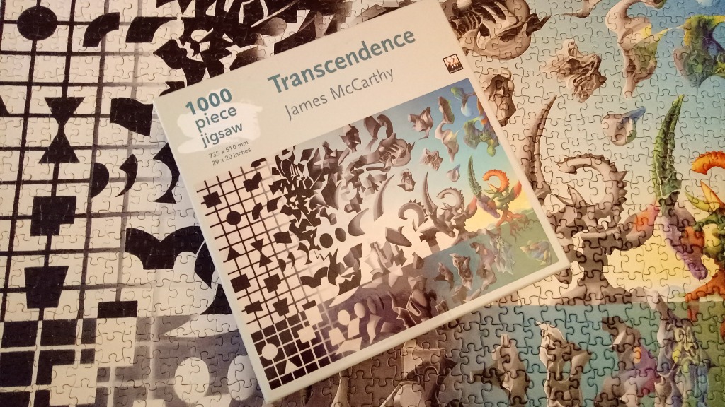 "Transcendence" jigsaw puzzle by James McCarthy features abstract black & white shapes merging into colorful fantasy creatures.