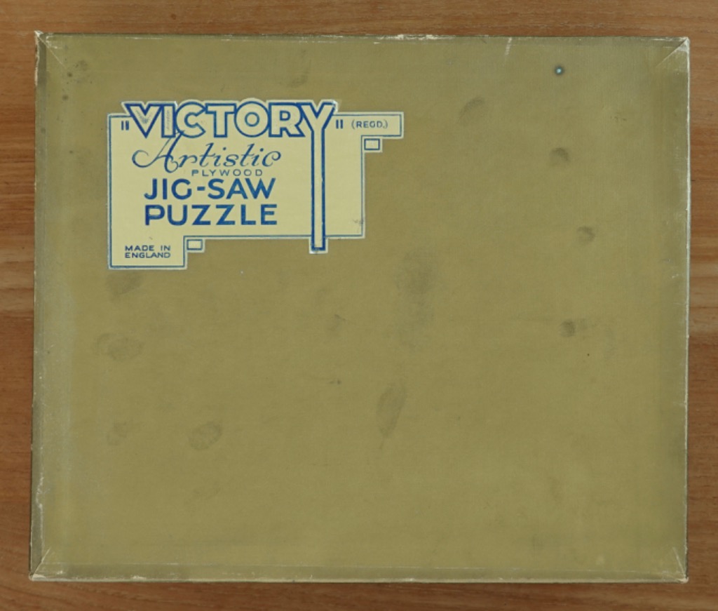 A rectangular olive-green surface featuring a geometric white and blue text-based graphic in the upper left corner.