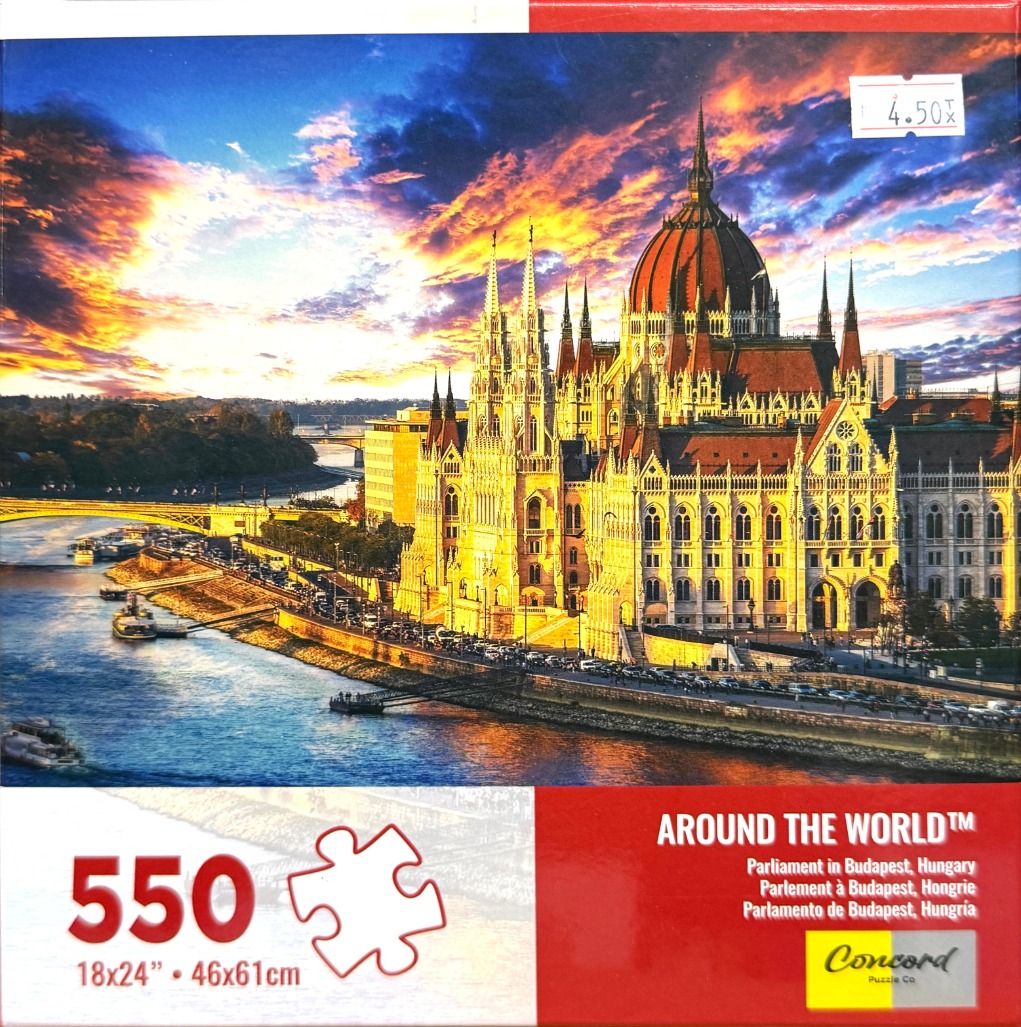 The Hungarian Parliament Building in Budapest at sunset overlooking the Danube River.
