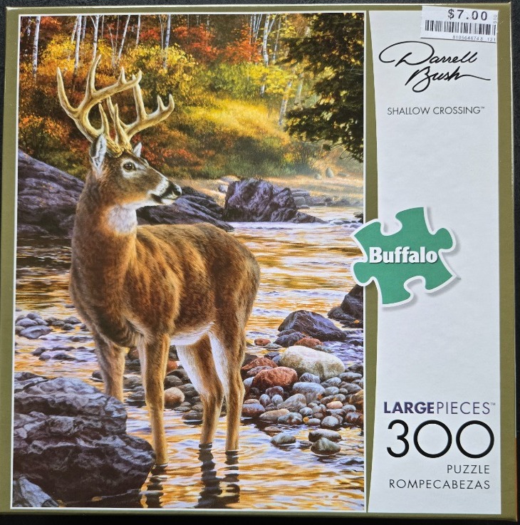 A realistic painting of a white-tailed buck standing in a shallow, rocky stream during a golden autumn forest scene.