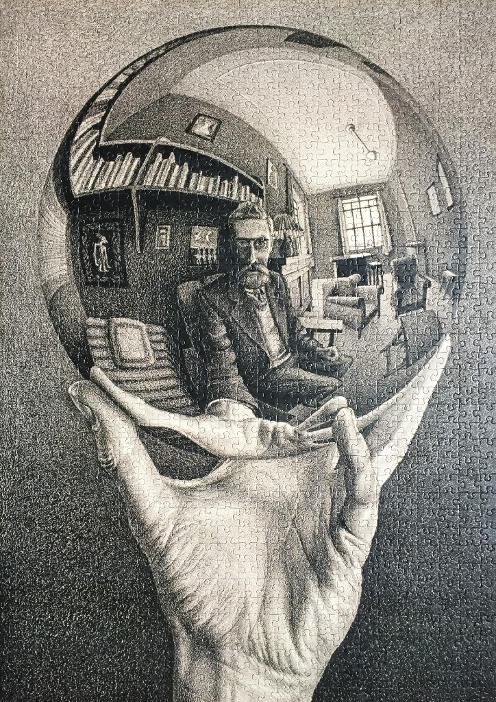 A black and white lithograph of a man's hand holding a reflective sphere showing a room and the artist's own self-portrait.