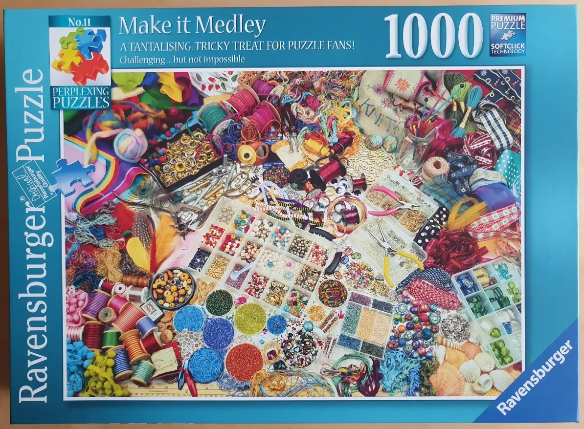 A high-angle view of a cluttered craft table filled with colorful beads, yarn, ribbons, and sewing notions.