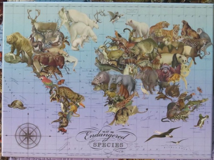 A world map composed of various endangered animals illustrated in a vintage scientific style.