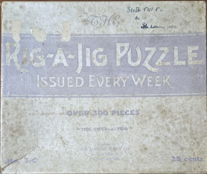 A vintage, weathered card with text in lavender and off-white tones reading The Rig-A-Jig Puzzle.