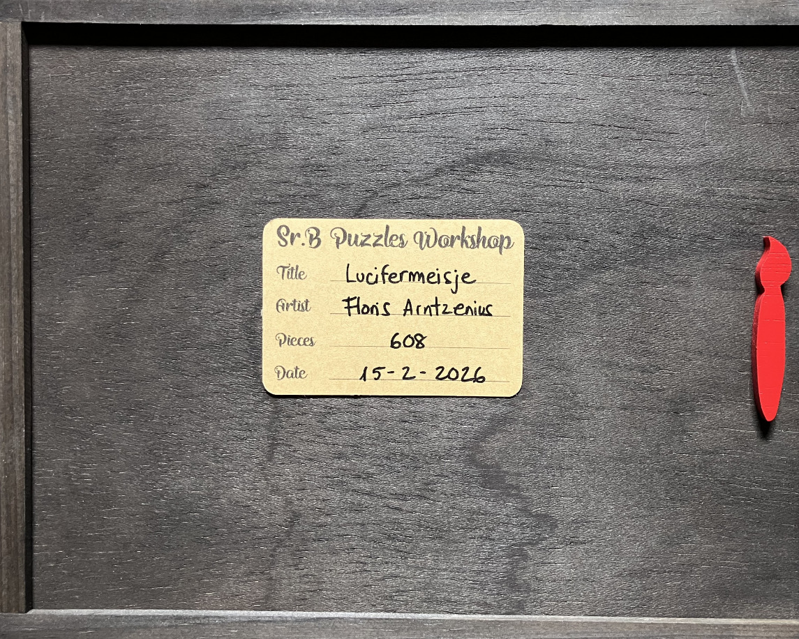 A wooden background with a tan informational label and a small red wooden paint brush icon.