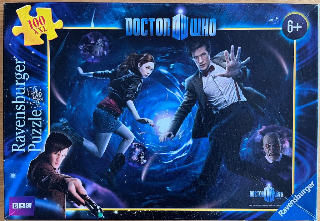 The Eleventh Doctor and Amy Pond against a dark blue cosmic vortex background.