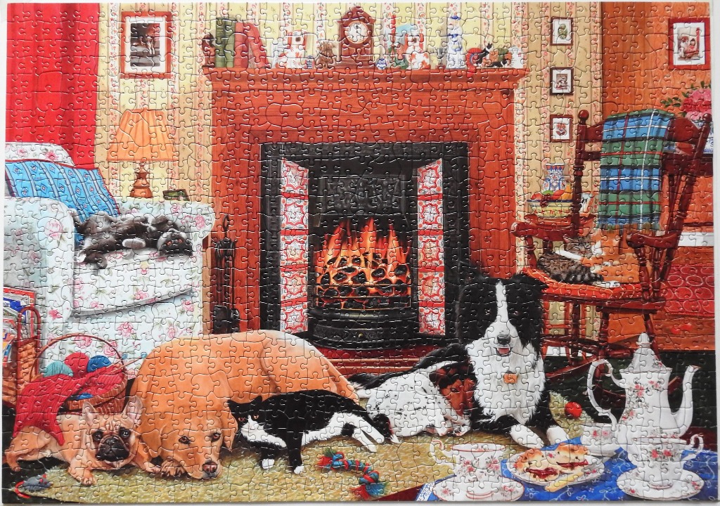 A cozy living room scene with several dogs and cats lounging in front of a fireplace.