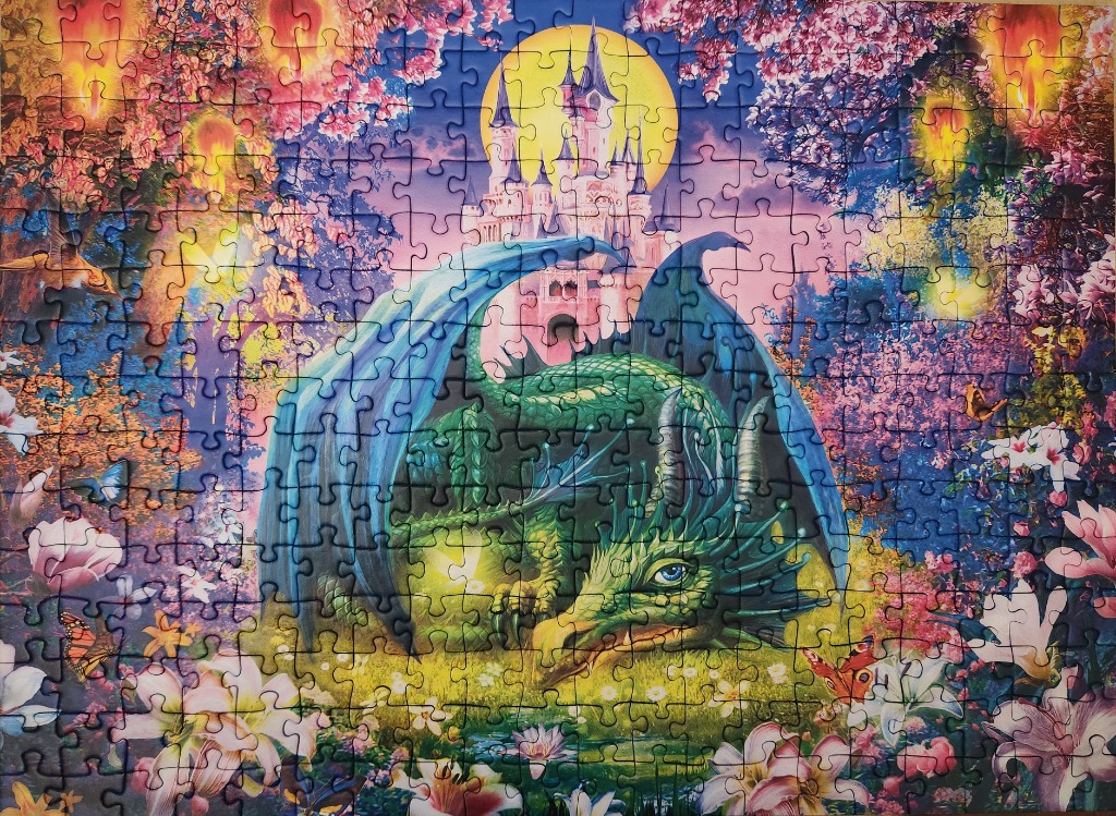 A green dragon resting in a vibrant, magical garden before a castle under a full moon.