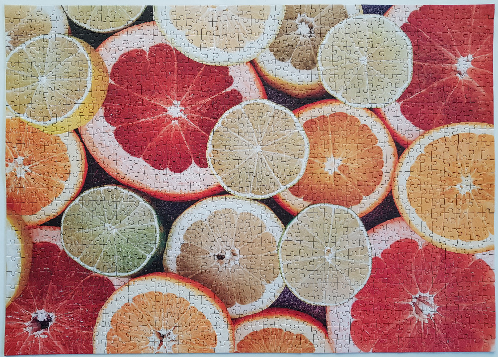 A close-up view of various citrus fruit slices arranged in a vibrant overlapping pattern.
