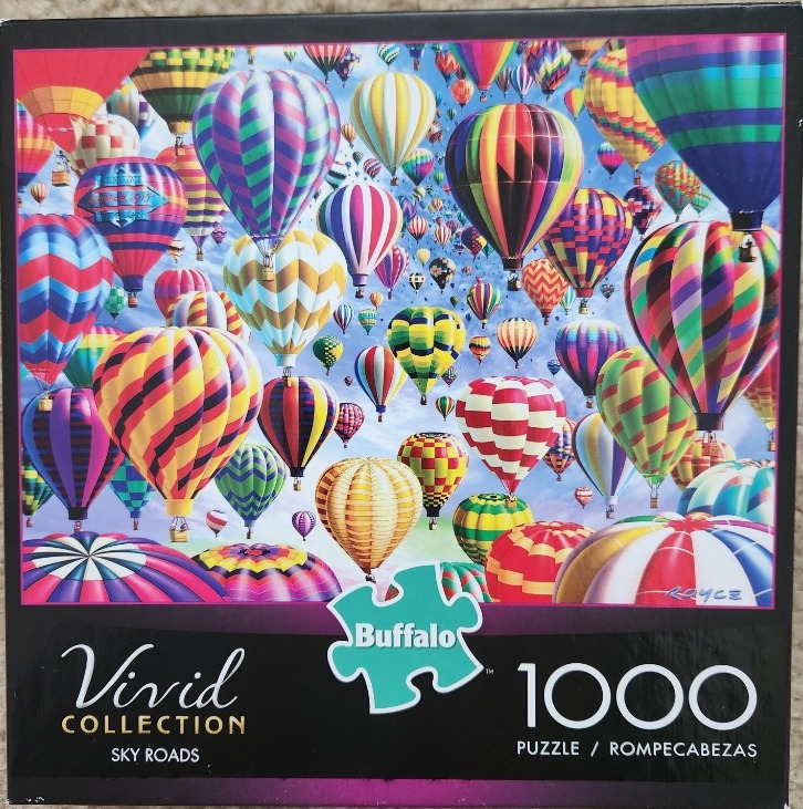 A dense sky filled with dozens of colorful hot air balloons in various patterns and sizes.