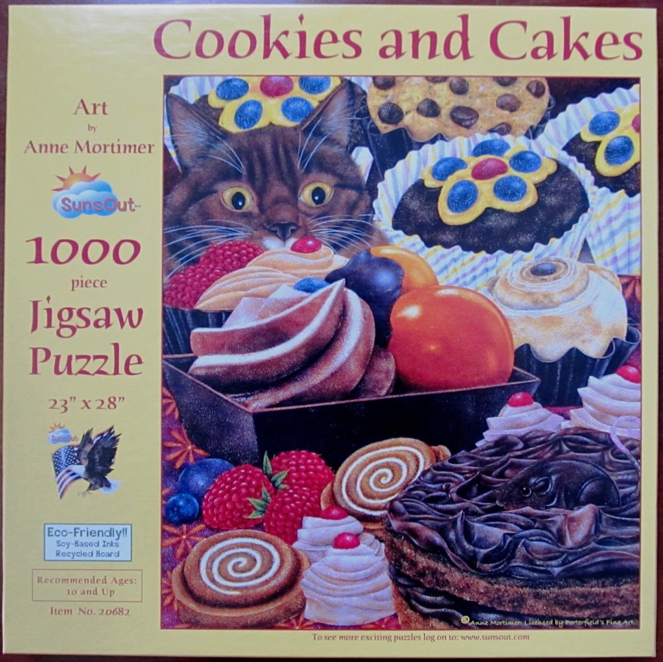 A curious cat peering over a display of assorted chocolate cupcakes, pastries, and fresh berries.