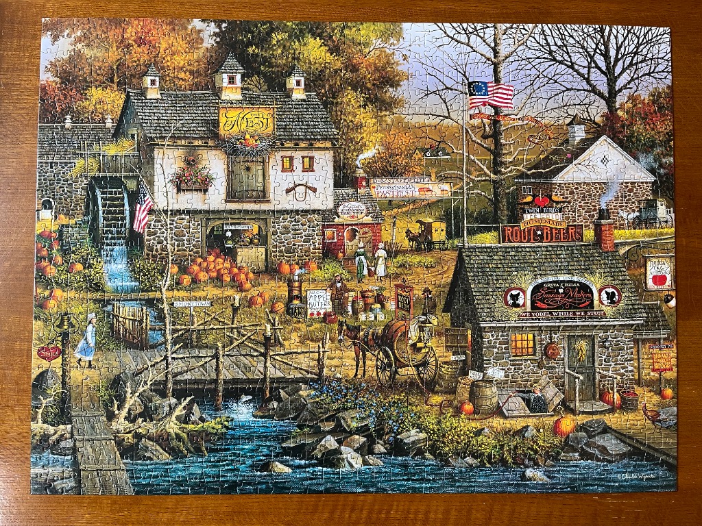 A nostalgic autumn scene of a mill and a sausage shop by a stream with horse-drawn carriages and pumpkins.