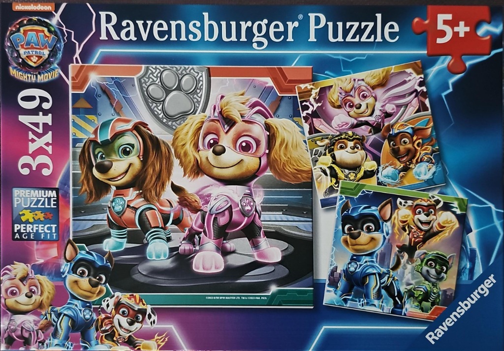 Animated dog characters from Paw Patrol The Mighty Movie in superhero costumes on a blue background