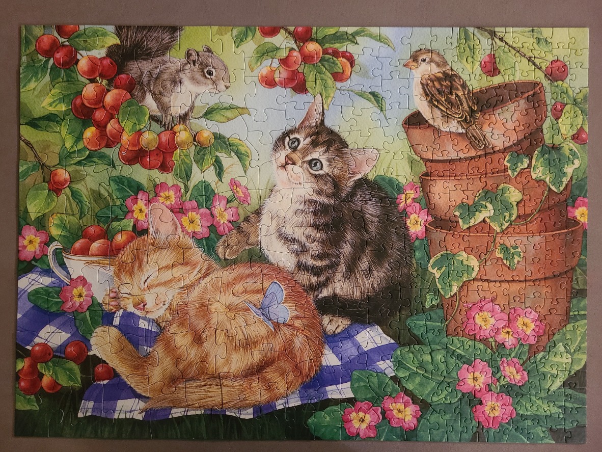 Two kittens, a squirrel, and a sparrow in a garden with cherries and flowers