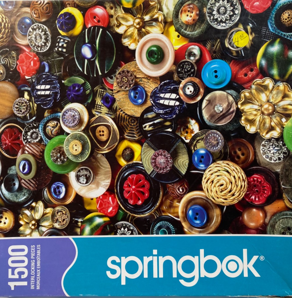 A dense, colorful collection of vintage buttons of various shapes, sizes, and materials.