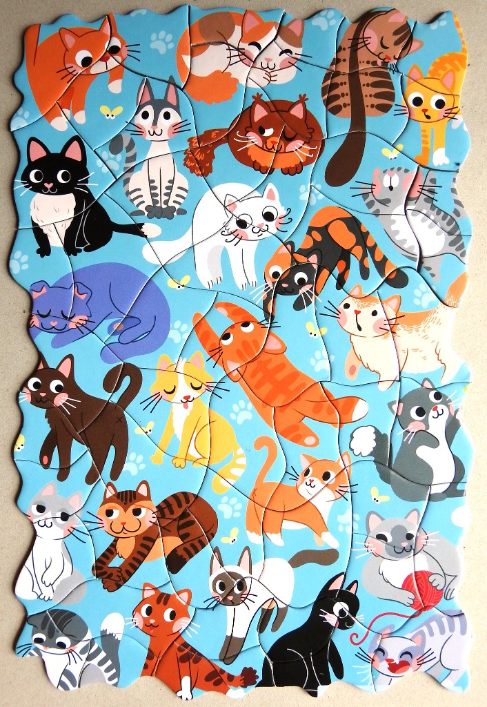 A whimsical illustration featuring a variety of cartoon cats on a bright blue background.
