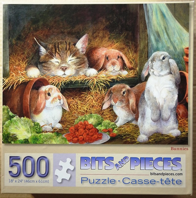 A tabby cat sleeping soundly next to three lop-eared rabbits in a cozy barn setting with hay, lettuce, and carrots.