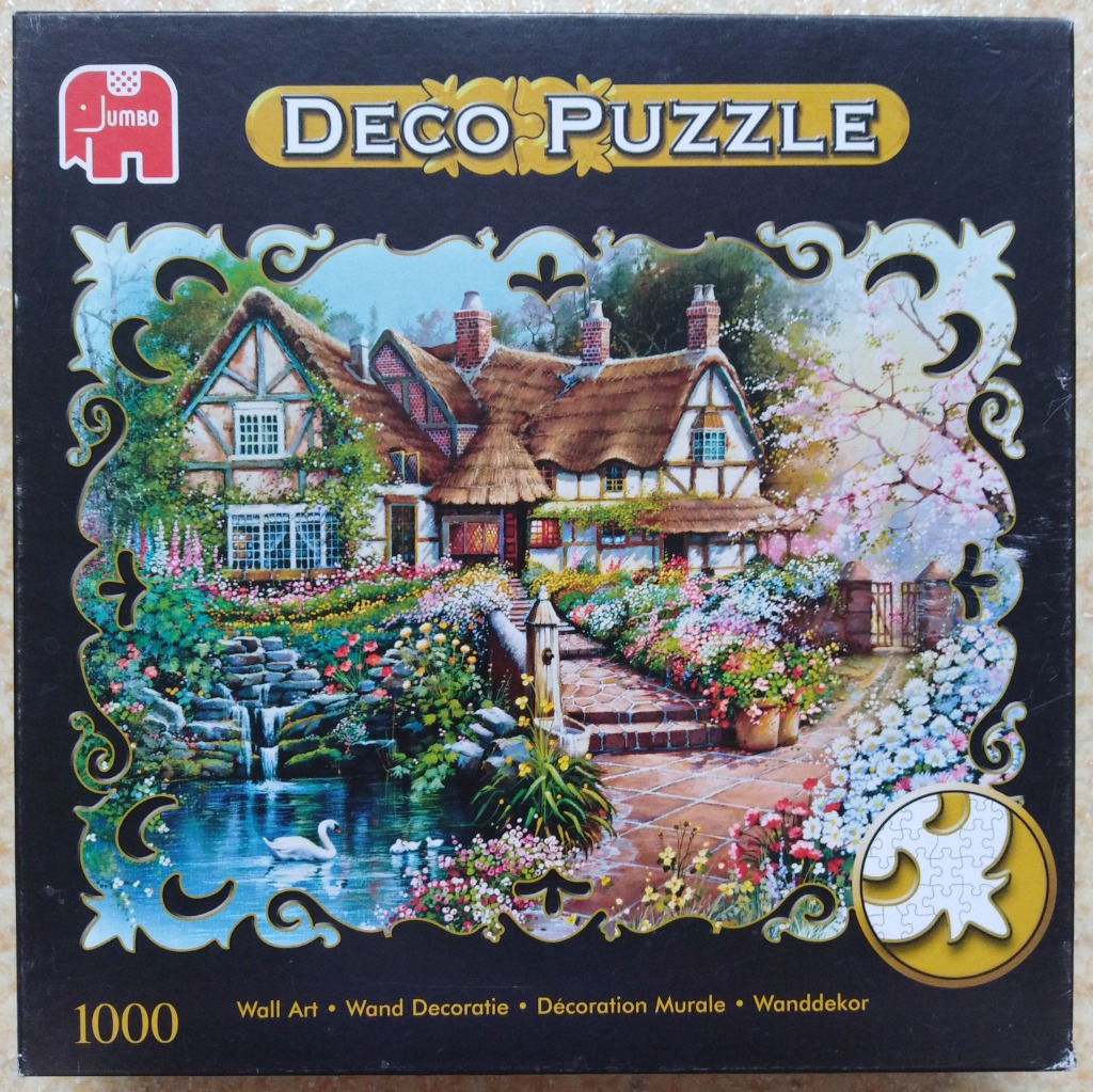 A thatched-roof cottage garden scene with a pond, a white swan, and colorful flowers, framed by decorative border art.