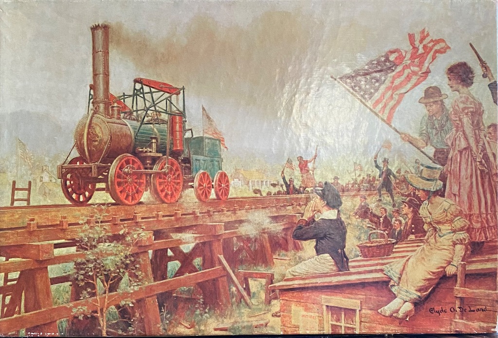Painting of an early steam locomotive crossing a wooden trestle bridge before a cheering crowd with American flags.
