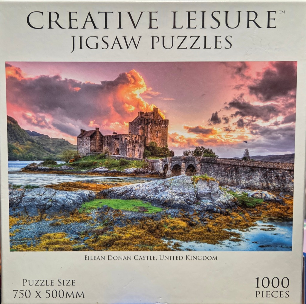 A photography-style image of Eilean Donan Castle in Scotland at sunset.