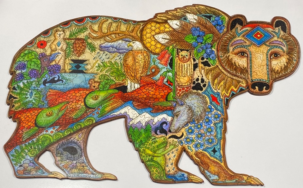 A whimsical illustration of a bear shaped like a silhouette, filled with North American wildlife and forest elements.