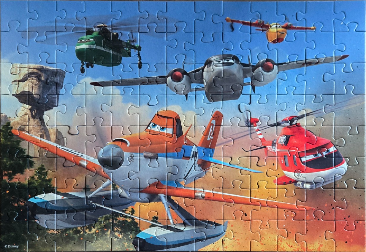 Animated firefighting planes and helicopters flying over a desert landscape