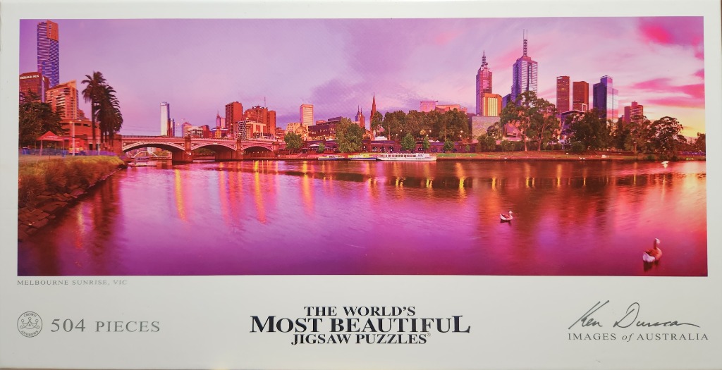 Panoramic view of Melbourne city skyline reflected in the Yarra River at sunset.