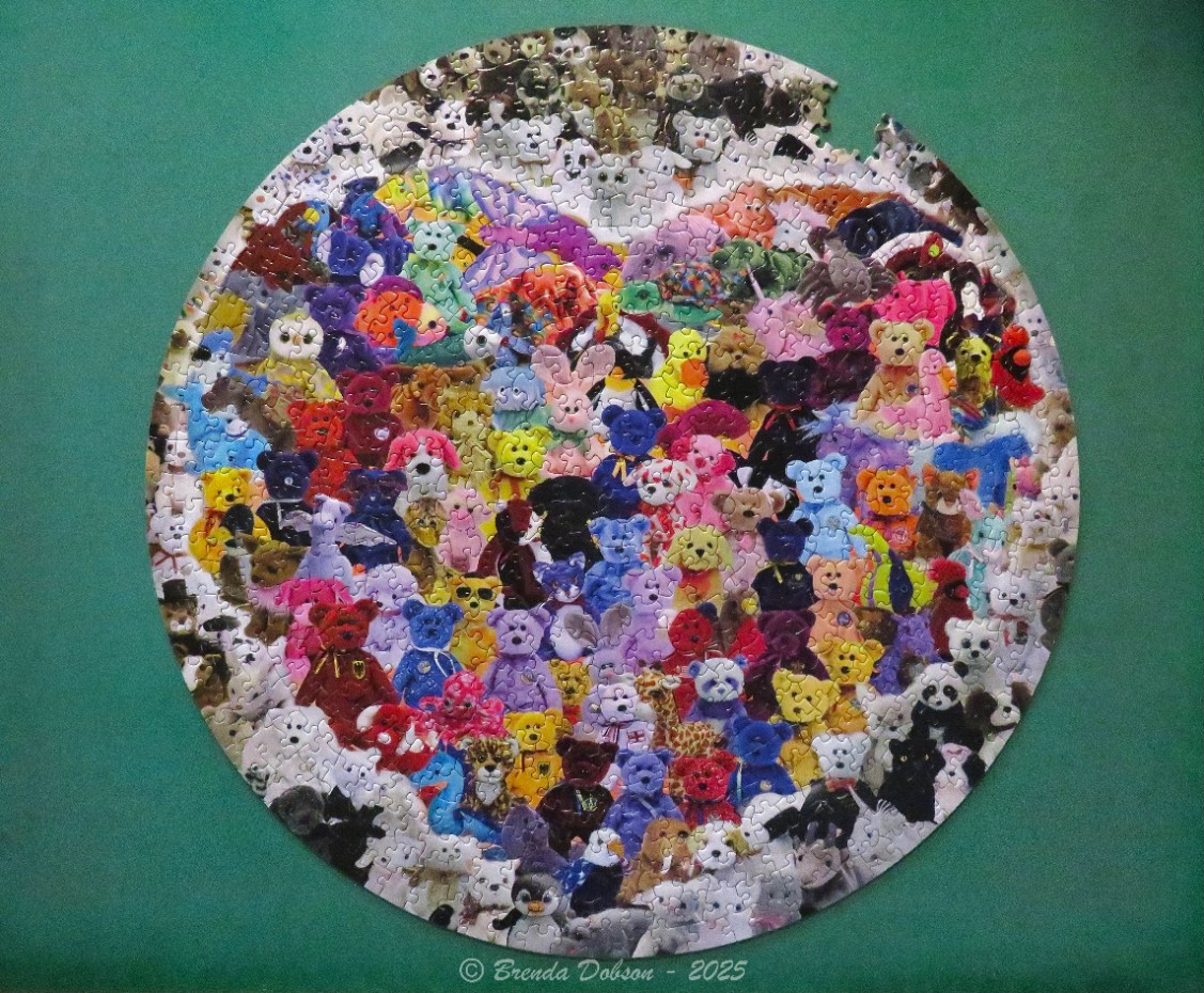 A circular collage of many colorful, small plush toy animals and teddy bears.