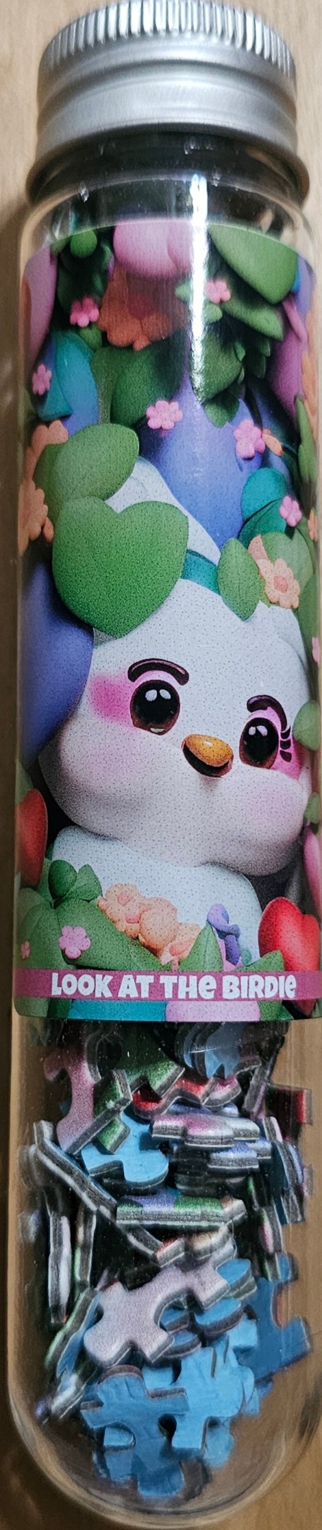 A cute white bird character peeking out from behind green heart-shaped leaves and pink flowers.