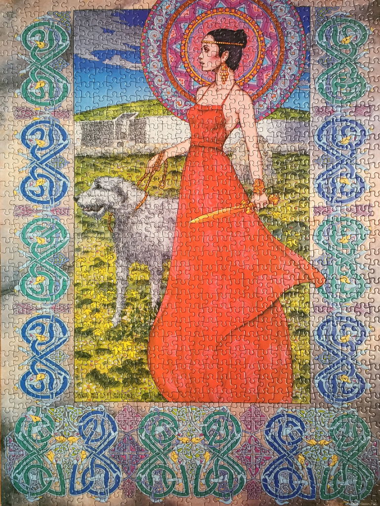 A woman in a vibrant red dress holding a large dog against a Celtic-inspired landscape background.