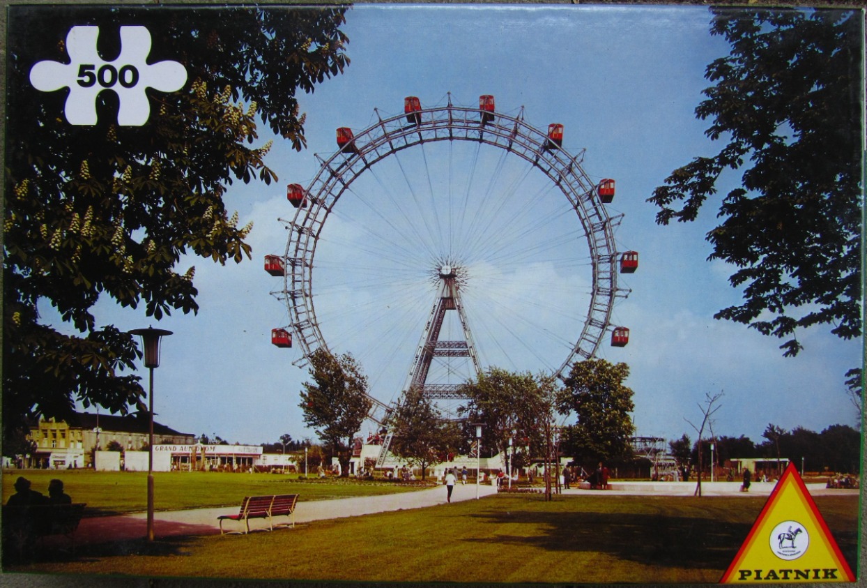 A photograph of the Wiener Riesenrad ferris wheel in Vienna, surrounded by trees and a park.