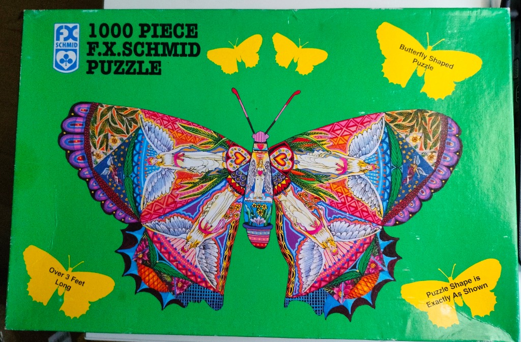 A detailed illustration of a butterfly with ornate, angel-themed wings against a bright green background.