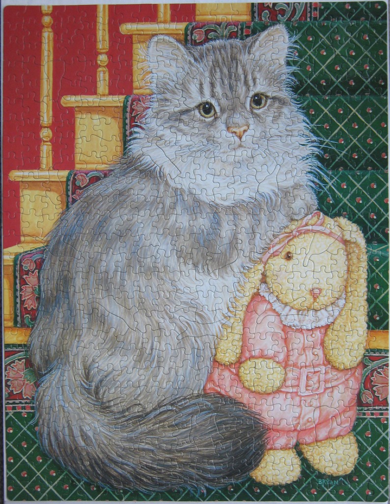A fluffy grey tabby cat sitting on stairs next to a stuffed toy rabbit.