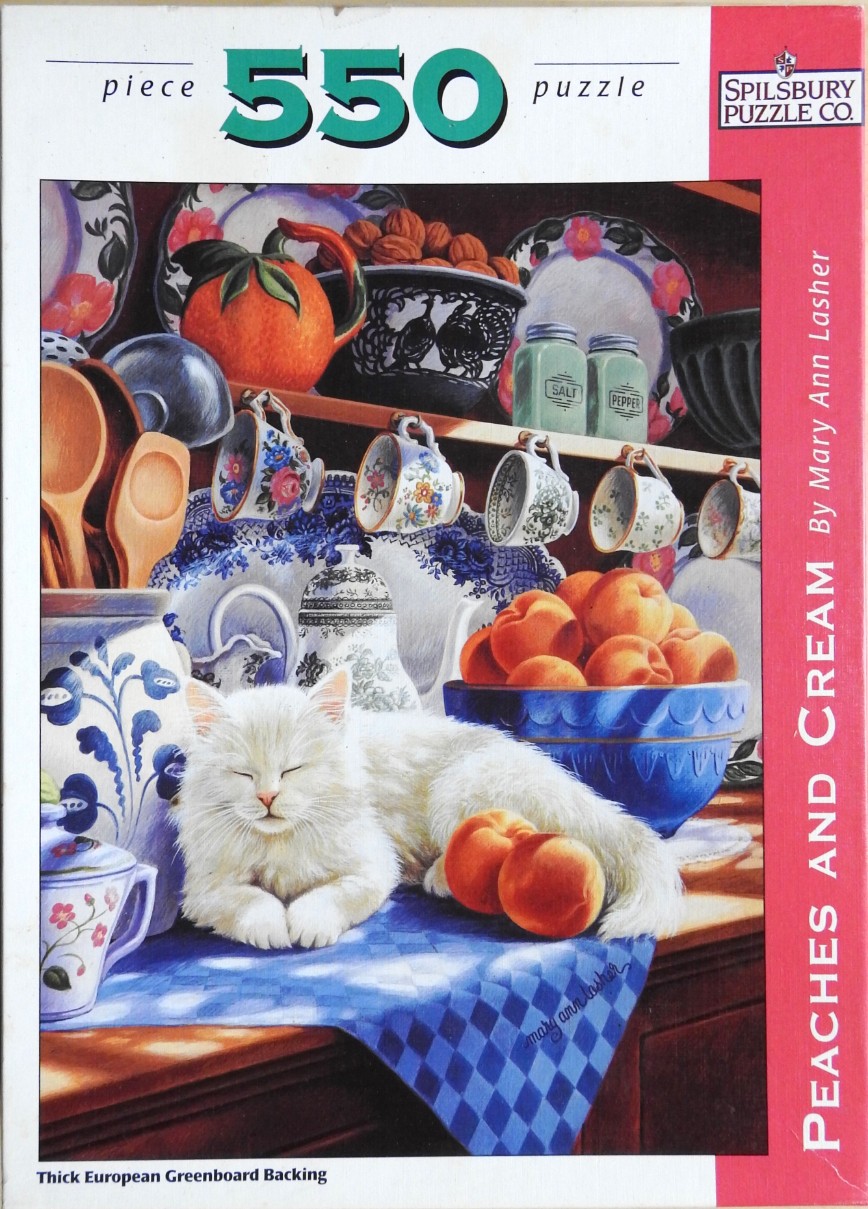A fluffy white cat napping on a blue checkered cloth in a kitchen with peaches and china.