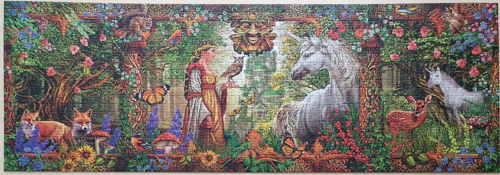 A panoramic fantasy illustration featuring a maiden, a unicorn, and various forest creatures in a lush woodland setting.