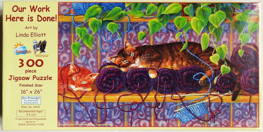 Two tabby cats sleeping among balls of yarn on a wooden shelf beneath a trailing green plant.