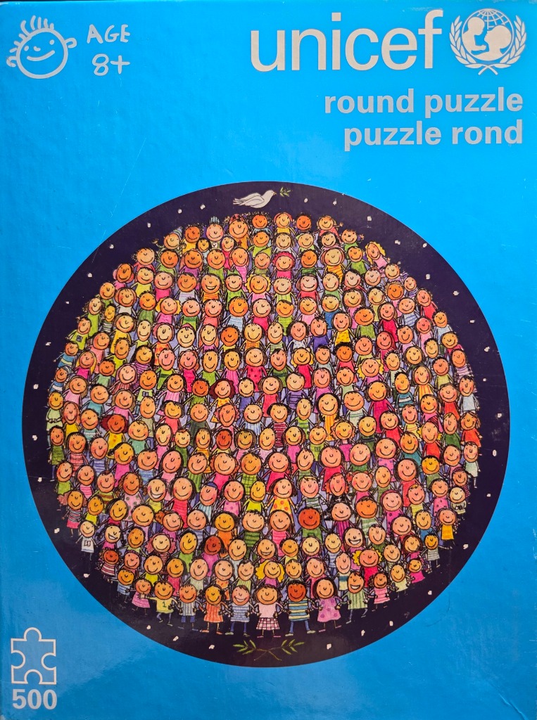A circular illustration of a large, diverse crowd of smiling children set against a deep blue starry night background.