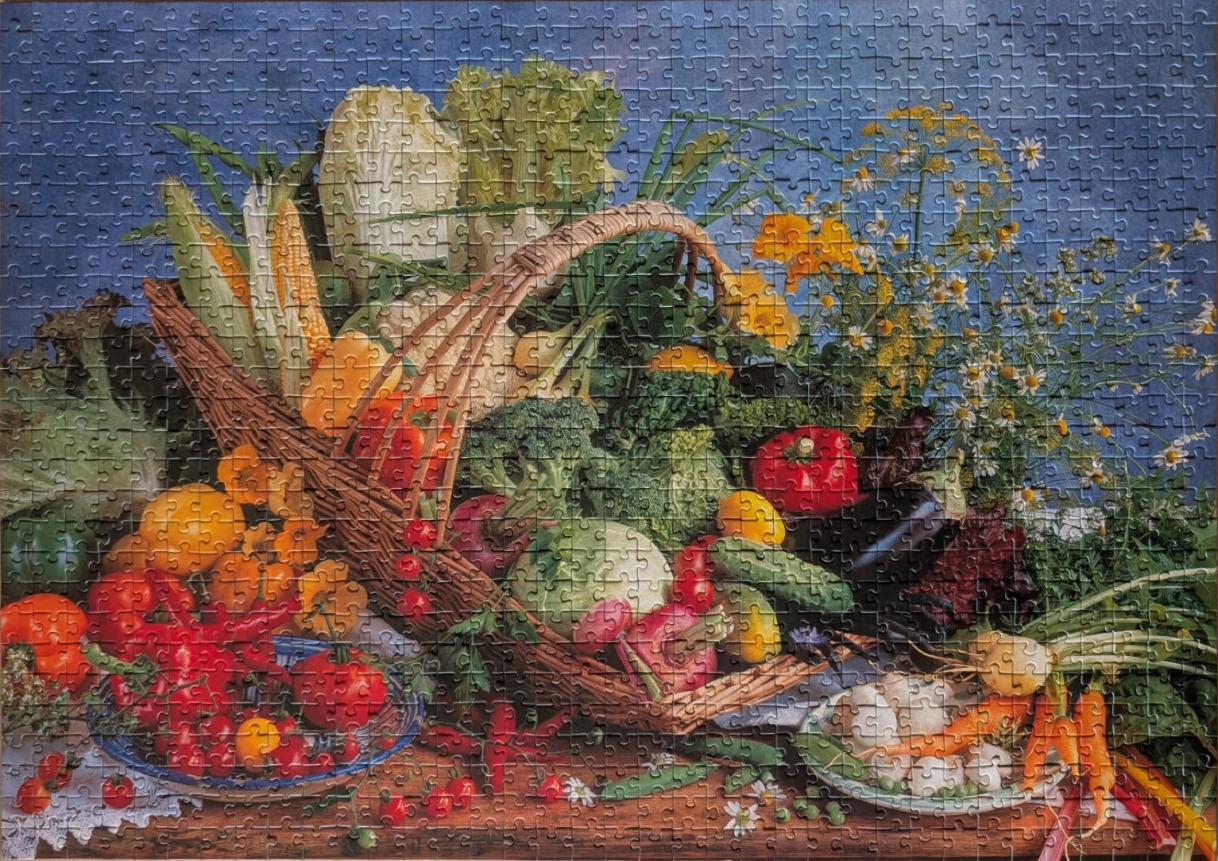 A bounty of fresh vegetables arranged in and around a rustic woven basket on a wooden table.