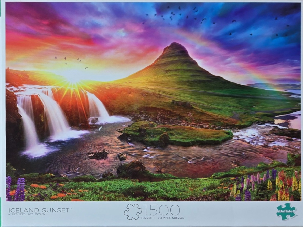 A dramatic sunset over Iceland's Kirkjufell mountain with a waterfall, rainbow, and lupine flowers.